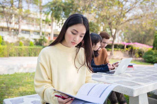 istock Asian students use notebook computers and tablet to work and study online in the garden at home during the coronavirus epidemic and quarantine at home 1221548406