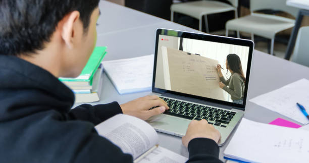 istock Asian students use notebook and tablet computers to work and study online at home during the coronavirus epidemic and quarantine at home 1221548421