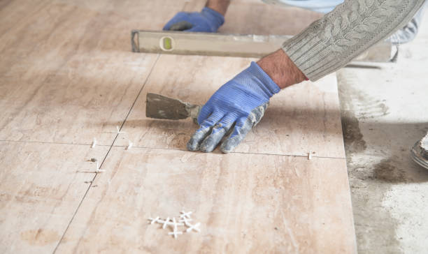istock Laying floor ceramic tile. Renovating the floor 1221549415