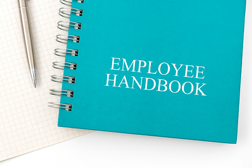 Manual del empleado o manual con un bolígrafo y papel en una mesa blanca en una oficina. photo