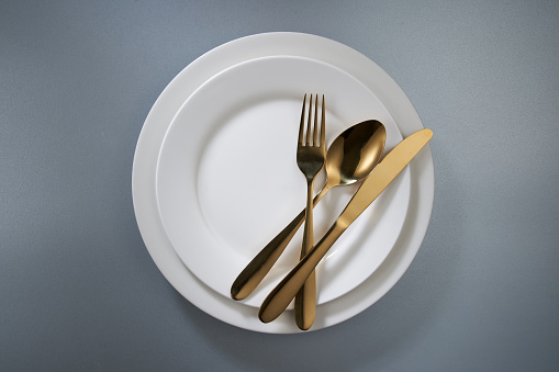top view dinner plate and eating utensil