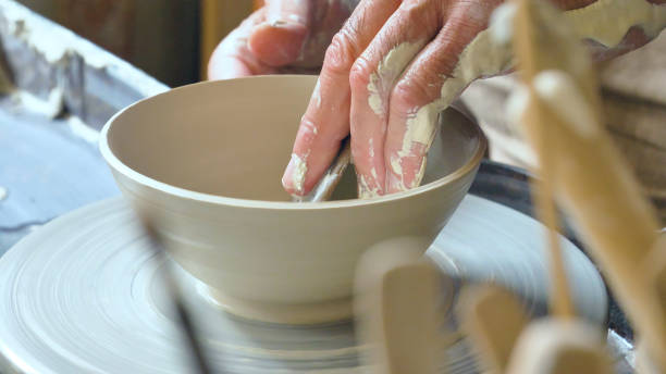 istock Portrait of an elderly artisan in his creative workshop who handmade clay and mold to create home-made jars and works of art 1221551996