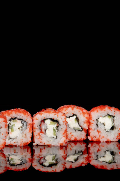 istock Philadelphia roll with salmon, cheese and cucumber on a black background with reflection. Sushi Philadelphia 1221552356