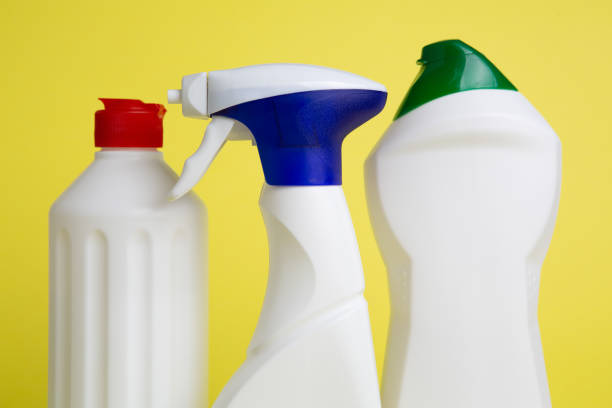 istock Three cans of cleaning products on yellow background 1221553393