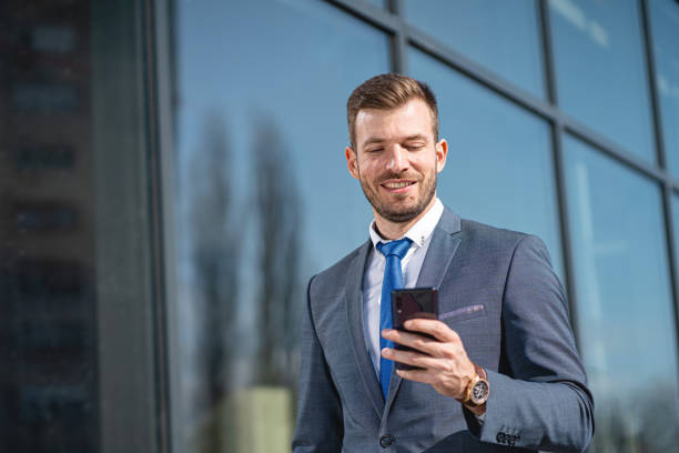 istock Smiling businessman using cellphone on the way to work 1221554269