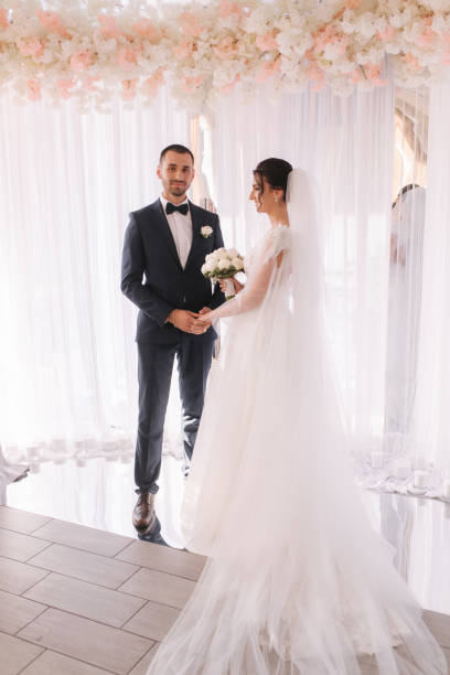istock Groom and bride read their wedding vows. Love each other 1221555361