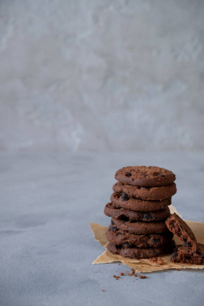 istock Stack of fresh homemade crispy cookies with dark chocolate.On a gray background. Copy space 1221557311
