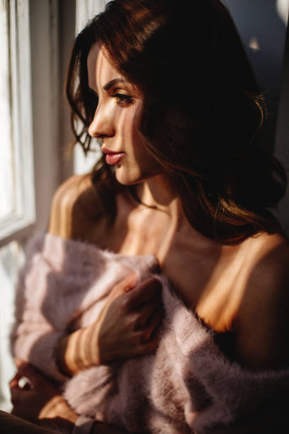 istock Beautiful girl by the window. 1221560853