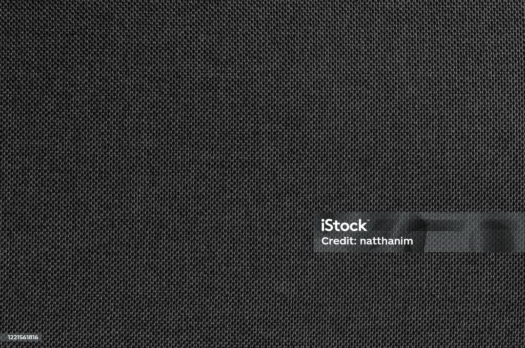 Black grey fabric texture for background and design art work with seamless pattern of natural textile. Textured Stock Photo