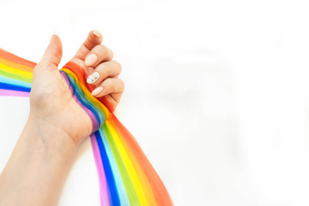 istock hand with unicorn manicure on white background 1221561861