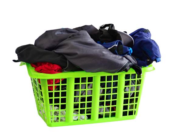 istock Basket full of laundry isolated on white 1221562472