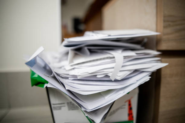 istock Pile of documents on desk stack up high waiting to be managed. 1221563808