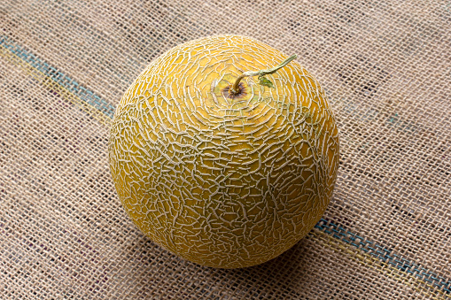 sweet, yellow melon on burlap