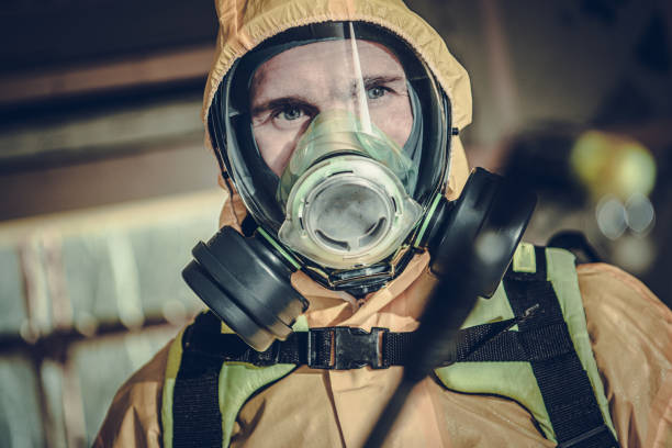 Disinfection and Sanitizing Worker Fighting Virus Pandemia Caucasian Disinfection and Sanitizing Worker Wearing Professional Biochemical Mask with Two Filters on Both Sides of the Mask. Fighting Virus Spread. biohazard cleanup stock pictures, royalty-free photos & images
