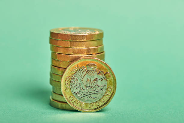 istock New Pound Coins On Colour Background 1221570220