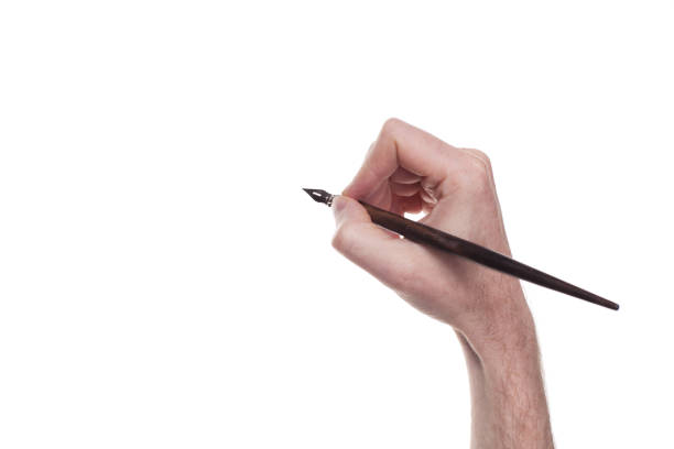 istock hand with pen antique writing isolated over white background 1221570366