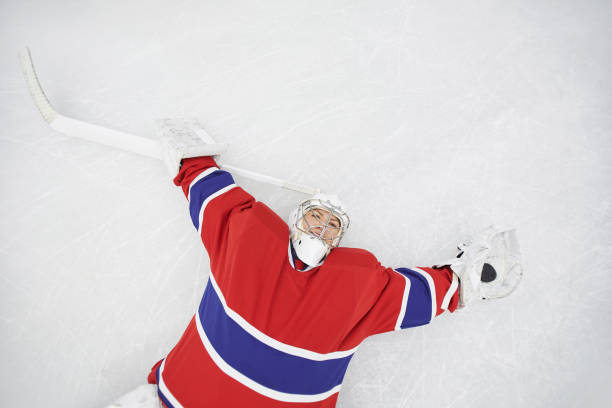 istock Female Hockey Player Lying on Ice 1221570606