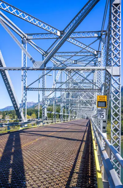 Photo of Silver truss transport metal bridge over the Columbia River connects the two states of Oregon and Washington to Columbia Gorge national reserve