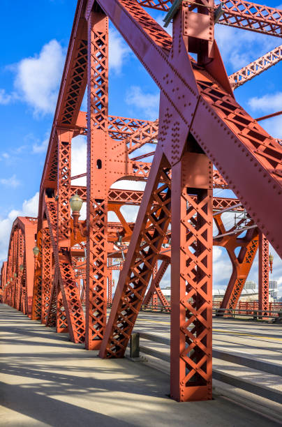istock Red trusses constructing a Broadway drawbridge over the Willamette River in Portland with long shadows from bright sunlight 1221580998