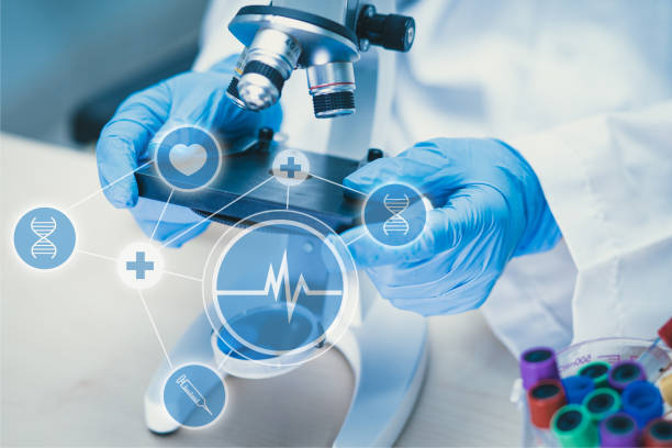 istock Scientist biochemist or microbiologist working research with a microscope in laboratory. For protect outbreak Coronavirus Covid19, bacteria and germs. 1221581126