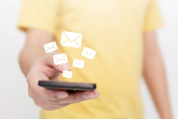 istock Close-up image hand using smartphone with icon envelope email. Contact us customer service or e-mail marketing concept 1221581382