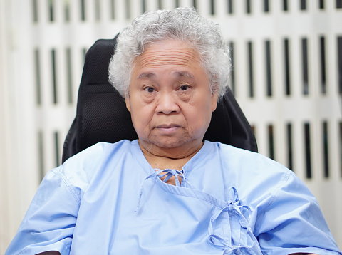 Asian senior or elderly old lady woman patient smile bright face while sitting on wheelchair in nursing hospital ward : healthy strong medical concept.