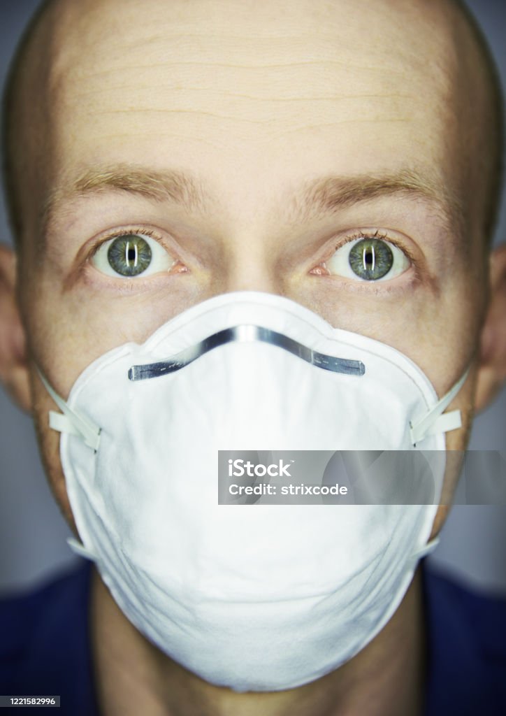 Closeup portrait of man wearing protective mask against virus and pollution Adult Stock Photo