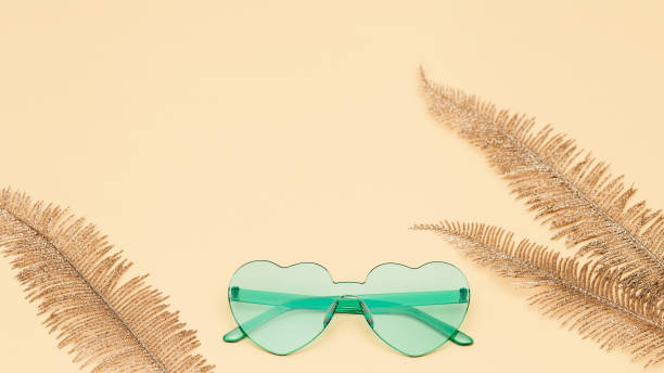 istock Creative top view with modern sunglasses on paper background. Heart shaped eyeglasses pastel colored. Summer concept. Banner for website with copy space. 1221583807