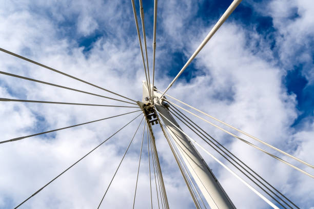 istock Low angle view looking directly upwards at bridge supports against a cloudy sky 1221583889