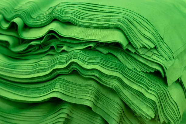 istock Cloth sports mesh folded into a stack of bright green color close-up. 1221584947