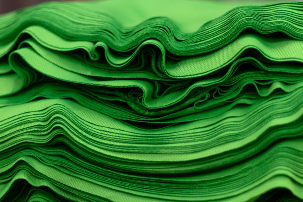 istock Cloth sports mesh folded into a stack of bright green color close-up. 1221584977