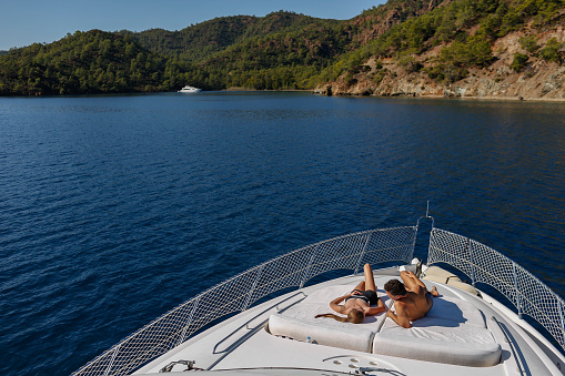 Couple Sunbathing On Yacht