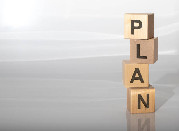 istock PLAN word on a wooden cubes on white grey glossy background with reflection 1221586904