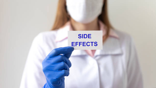 istock Side Effects - Medical doctor shows information on a paper with blurring background 1221586941