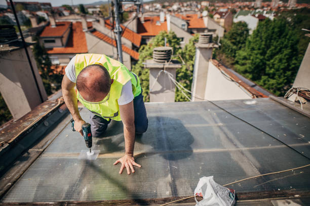 istock One workman with electric screwdriver repairs the roof 1221589902