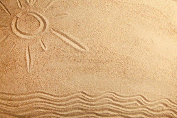 istock Drawing of the summer sun on a sandy beach with copy space. View from above 1221591701