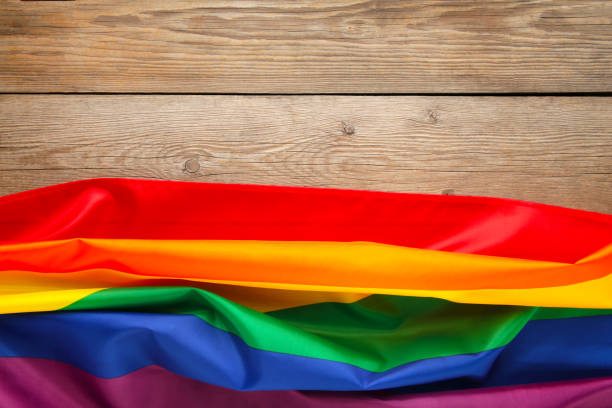 istock Rainbow LGBT flag on grey wooden background with copy space 1221592207