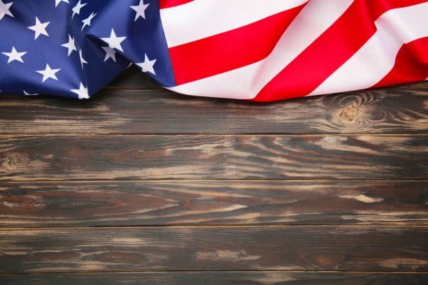 istock American flag on brown wooden background with copy space 1221592791