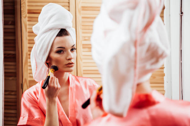 istock girl after shower makes makeup in the bathroom 1221593139