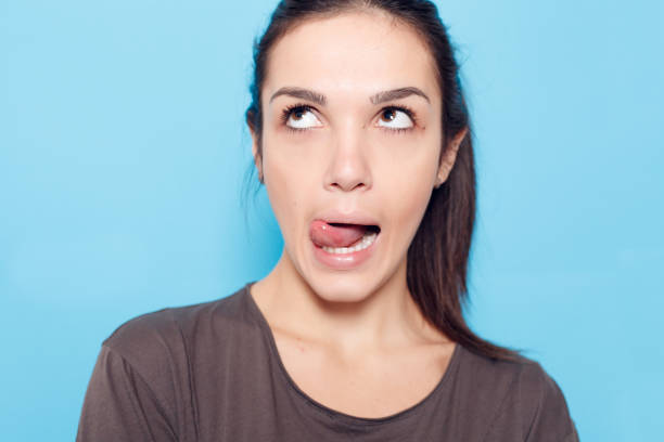 istock Beautiful smiling woman on blue background. 1221594465