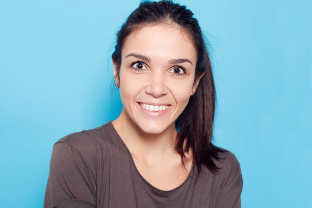 istock Beautiful smiling woman on blue background. 1221594466
