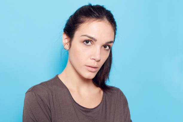 istock Beautiful smiling woman on blue background. 1221594508