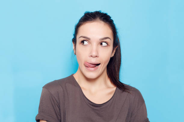 istock Beautiful smiling woman on blue background. 1221594525