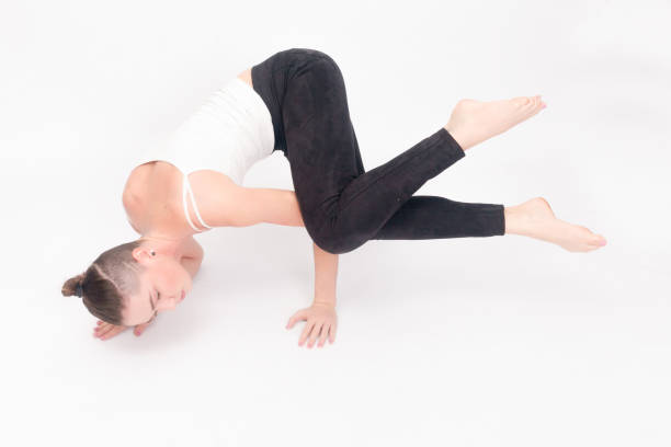 istock Young woman doing yoga exercise 1221595070