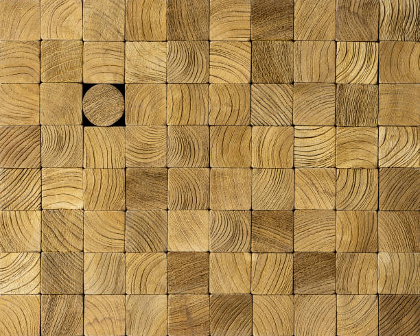 istock Many square wood blocks stacked up with one different round block within the other square blocks, standing out from the crowd concept. 1221595107