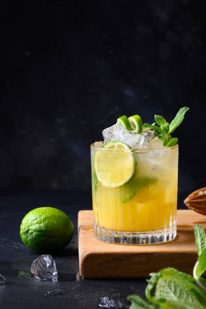 istock Mai Tai Classic rum cocktail. Tropical lemonade with lime on black. Vertical format. 1221595122