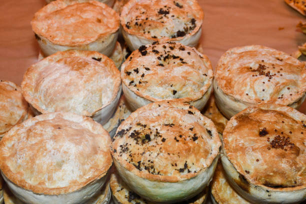 British pie stuffed in display window, for sale