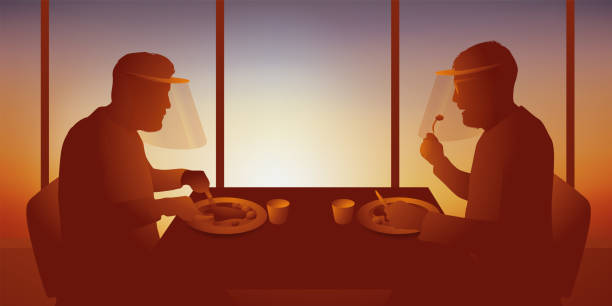 istock Two men eat one-on-one while wearing masks, to comply with health protection measures during a pandemic. 1221596756