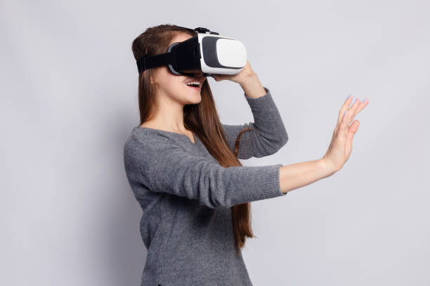 istock Woman with virtual reality goggles. Studio shot, gray background 1221597891