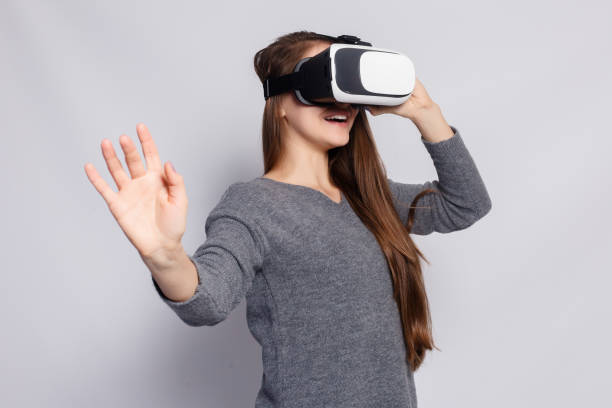istock Woman with virtual reality goggles. Studio shot, gray background 1221597998